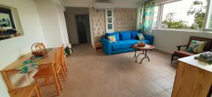 a living room with a blue couch and a table at Blue Mediterranean Apartments in Sveti Stefan