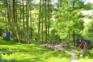 a backyard with a picnic table and a hammock at Trzy Strumyki in Kąty Bystrzyckie
