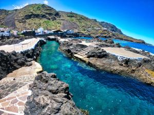 a body of water with a mountain in the background at Garachico Homes - LA CASA DE LINA in Garachico
