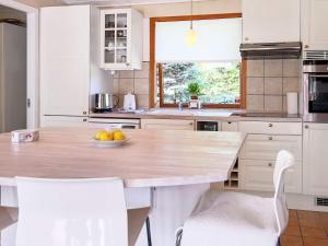 a kitchen with a table with a bowl of fruit on it at 6 person holiday home in Gilleleje in Gilleleje