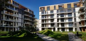 an image of an apartment complex with grass roofs at atHome Suites in Kraków