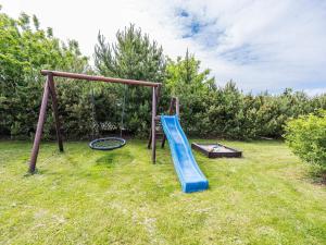 a playground with a blue slide at Secluded Cozy Cottage in Skaven-By Traum in Tarm