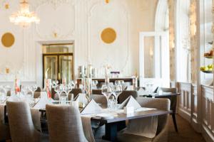 a restaurant with tables and chairs in a room at Elite Grand Hotel Gävle in Gävle