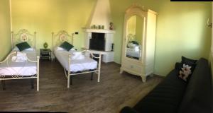 a living room with two beds and a tv at B&B Villa Jonica in Gallipoli