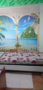 a bedroom with a bed with a painting of palm trees at appartamento Claudia in Roccalumera