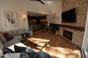 a living room with a couch and a fireplace at Wintergreen 10 in Thredbo