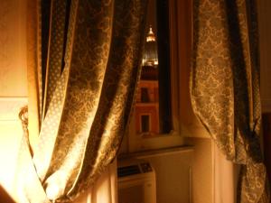 a curtain on a window in a room at Hotel Emmaus in Rome