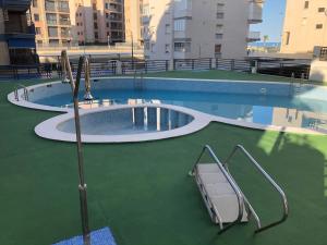 an empty swimming pool with two slides in the water at Miraplaya in Benicàssim