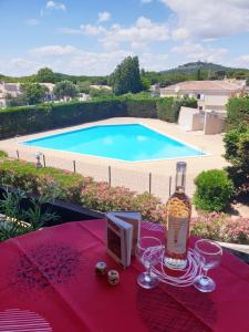 eine Flasche Wein auf einem Tisch mit Weingläsern in der Unterkunft Studio Port Vénus Village Naturiste in Cap d'Agde