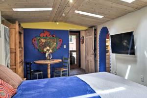 a bedroom with a bed and a table in it at Charming Casita Studio - Near Santa Fe Plaza! in Santa Fe