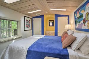 a blue bedroom with a large bed and a window at Charming Casita Studio - Near Santa Fe Plaza! in Santa Fe
