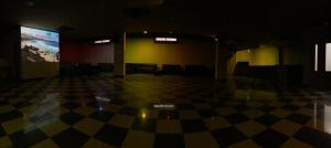 a room with a checkered floor and a projection screen at Hotel Pedramar in A Lanzada