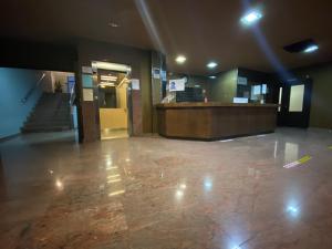 a lobby of a building with a door and a staircase at Hotel Pedramar in A Lanzada