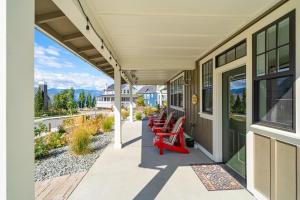 a row of red chairs sitting on a porch at Happy Hours #26 in Chelan