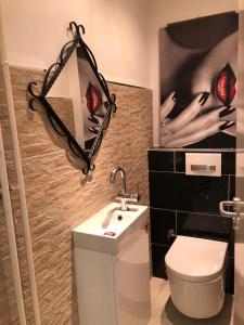 a bathroom with a white toilet and a sink at blau Wohnung in Karlsruhe