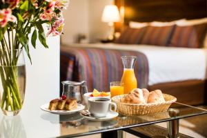 a glass table with a tray of breakfast food on it at Conde de Lemos Arequipa in Arequipa