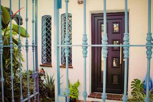a front door of a house with a blue fence at El carajo in El Rompido