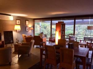 a restaurant with tables and chairs and a large window at Casa do Ouriço in Figueiró dos Vinhos