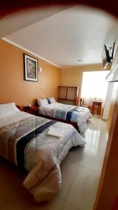 Ένα ή περισσότερα κρεβάτια σε δωμάτιο στο Hostal Capac