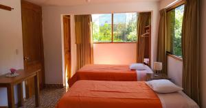 Postel nebo postele na pokoji v ubytování Tambo de Ollantay Hotel