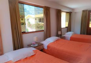 Postel nebo postele na pokoji v ubytování Tambo de Ollantay Hotel