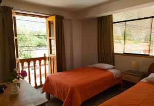 Postel nebo postele na pokoji v ubytování Tambo de Ollantay Hotel