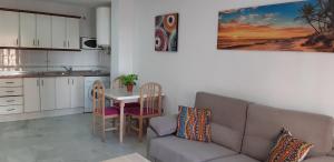 a living room with a couch and a table at Apartamento Junto a El Corte Inglés Algeciras 2 in Algeciras