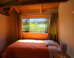 Postel nebo postele na pokoji v ubytování Tambo de Ollantay Hotel