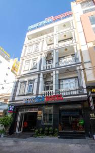 a large white building with a sign on it at Blue Sea Hotel Quy Nhơn - 02 Trần Độc in Quy Nhon