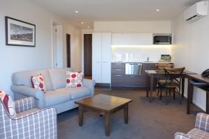 a living room with a couch and a table at West Meadows of Wanaka in Wanaka