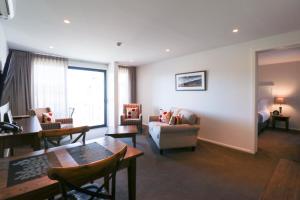 a living room with a couch and a table at West Meadows of Wanaka in Wanaka