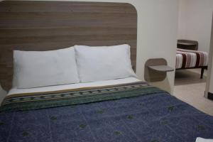 Postel nebo postele na pokoji v ubytování Hotel Winn Comfort