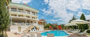 a hotel with a swimming pool and chairs at Hotel Panorama in Sveti Vlas