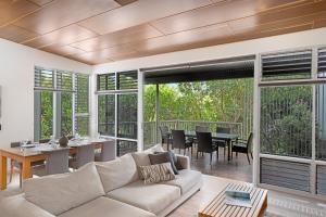 a living room with a couch and a table at Peppers Noosa Resort and Villas in Noosa Heads