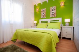 a green bedroom with a bed with a green wall at El Rincón Del Huroncillo in Tejina