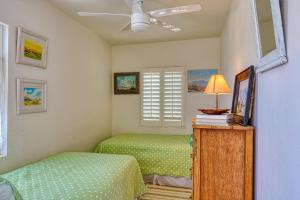 a bedroom with two beds and a window at Cactus Adobe in Twentynine Palms