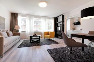 a living room with a couch and a table at SAXX Apartments Hagen in Hagen