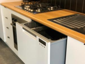 a white stove top oven sitting on top of a kitchen counter at BIG4 Yarra Valley Park Lane Holiday Park in Healesville