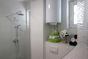 a bathroom with a shower and a window and a sink at Apartments Medulin - Orijeta in Medulin +37 photos