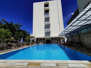 a large swimming pool in front of a building at Subhamitra Hotel Hua Hin-SHA Certified in Hua Hin