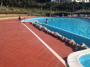a large swimming pool with people in the water at Residence Antigua in Bonifati