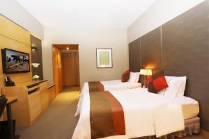 Ένα ή περισσότερα κρεβάτια σε δωμάτιο στο Jianguo Hotel Guangzhou
