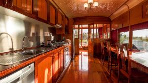 a kitchen with a sink and a counter top at Carriages Spa Retreat in Echuca