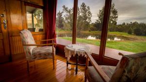 a room with a table and two chairs and a window at Carriages Spa Retreat in Wharparilla +8 photos