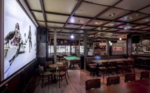 a restaurant with tables and chairs and a pool table at Hotel Seurahuone Riihimäki in Riihimäki