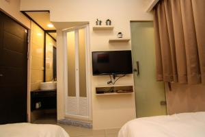 Postel nebo postele na pokoji v ubytování Mayu Hotel