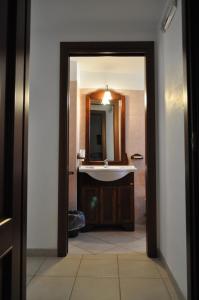 a bathroom with a sink and a mirror at B&B Villa Rosanna in Fasano