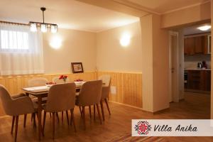 a dining room and kitchen with a table and chairs at Villa Anika in Mezek