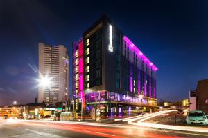 a building with purple lights on it on a city street at pentahotel Birmingham in Birmingham