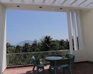 a balcony with a table and chairs and a view at Thanh Trang Hotel in Con Dao